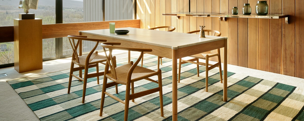 Willa Wool Rug, Morrison Dining Table and Wishbone Chairs in a dining room setting