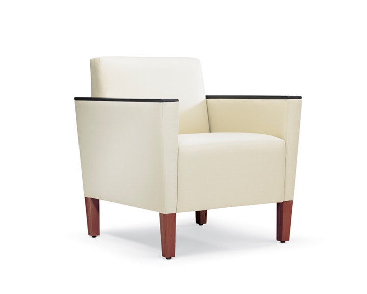 A three-quarter view of a Brava Classic Lounge Chair with white textile and urethane arm caps.