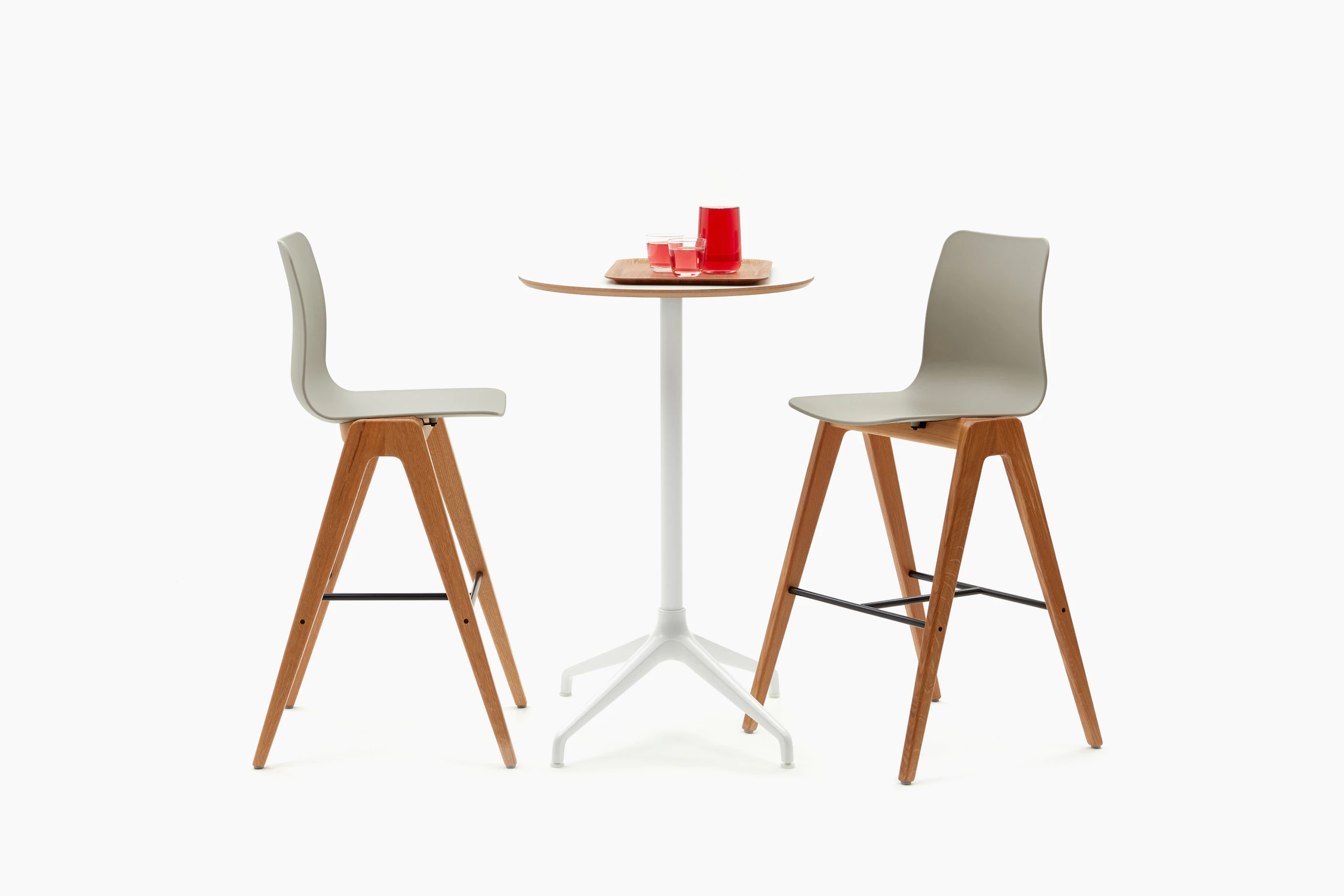 Ali Bar Height Table with white 4 star base and circular oak veneer table top with two wooden based bar Polly Stools.
