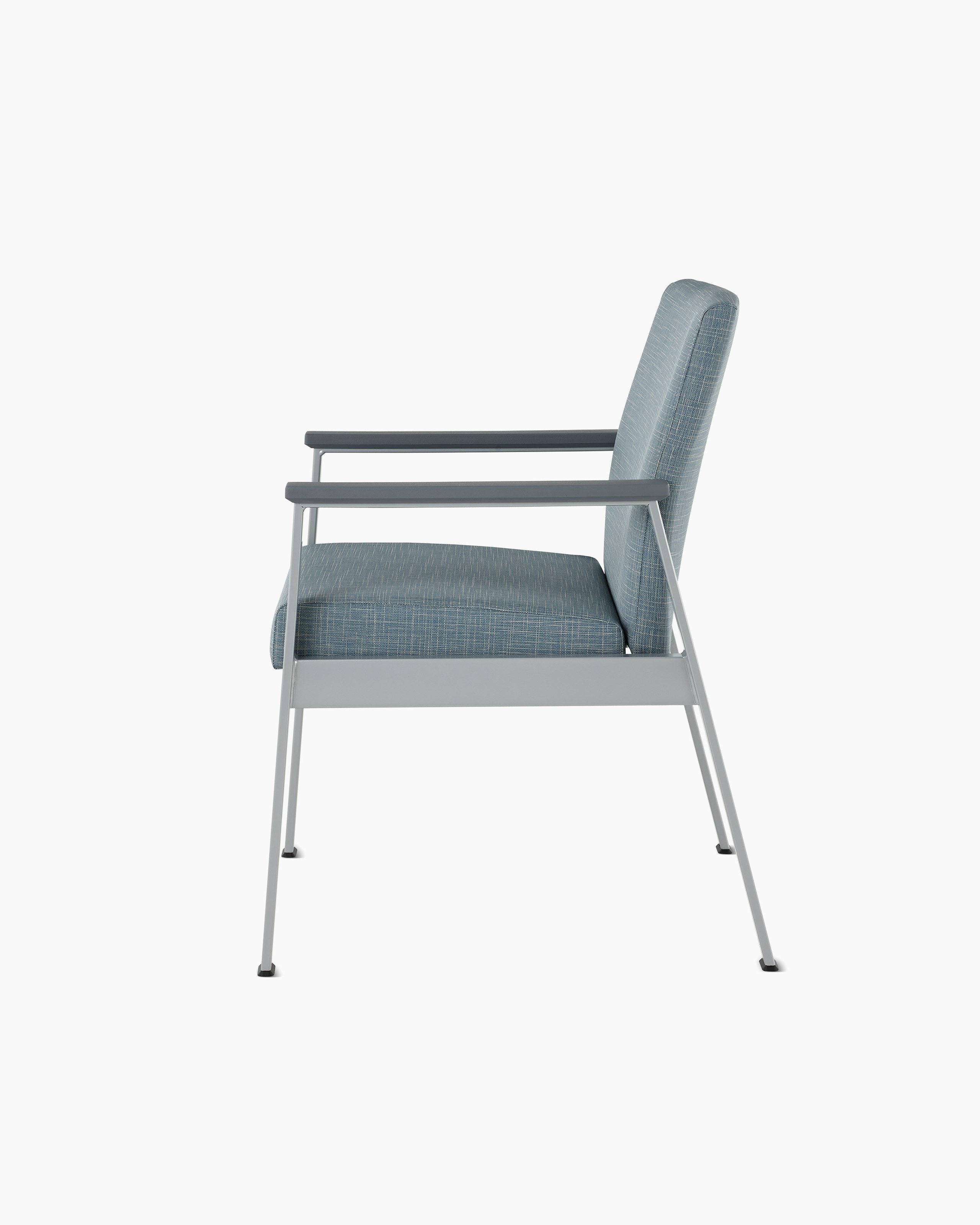 Side view of an Easton Side Chair with blue upholstery, metallic silver four leg base and slate grey arm caps.