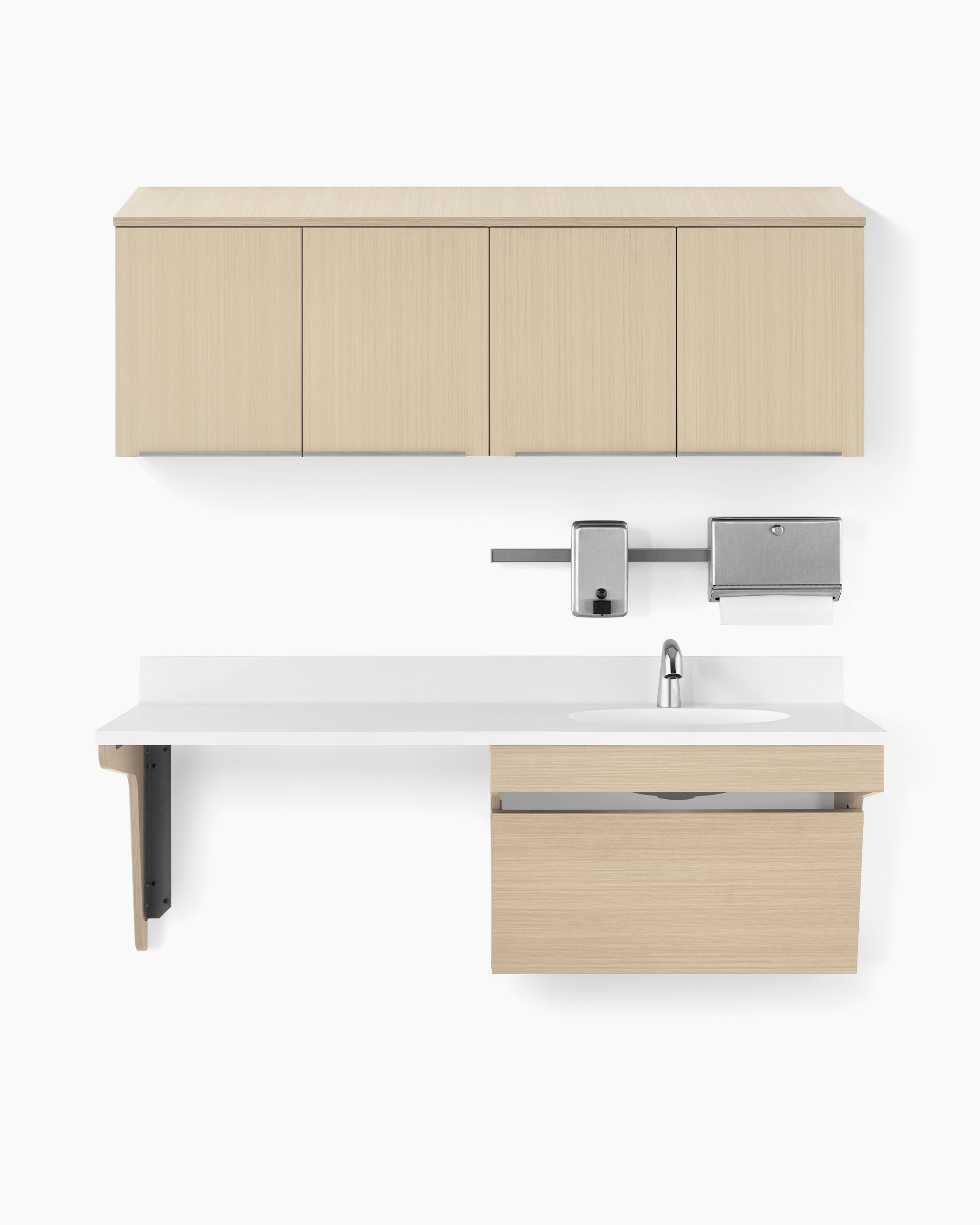 Wall-hung Mora casework with upper storage in an ash finish and a lower cabinet in an ash finish with a white solid surface top and ADA sink. Paper towel and soap dispenser are attached to a rail above the sink.