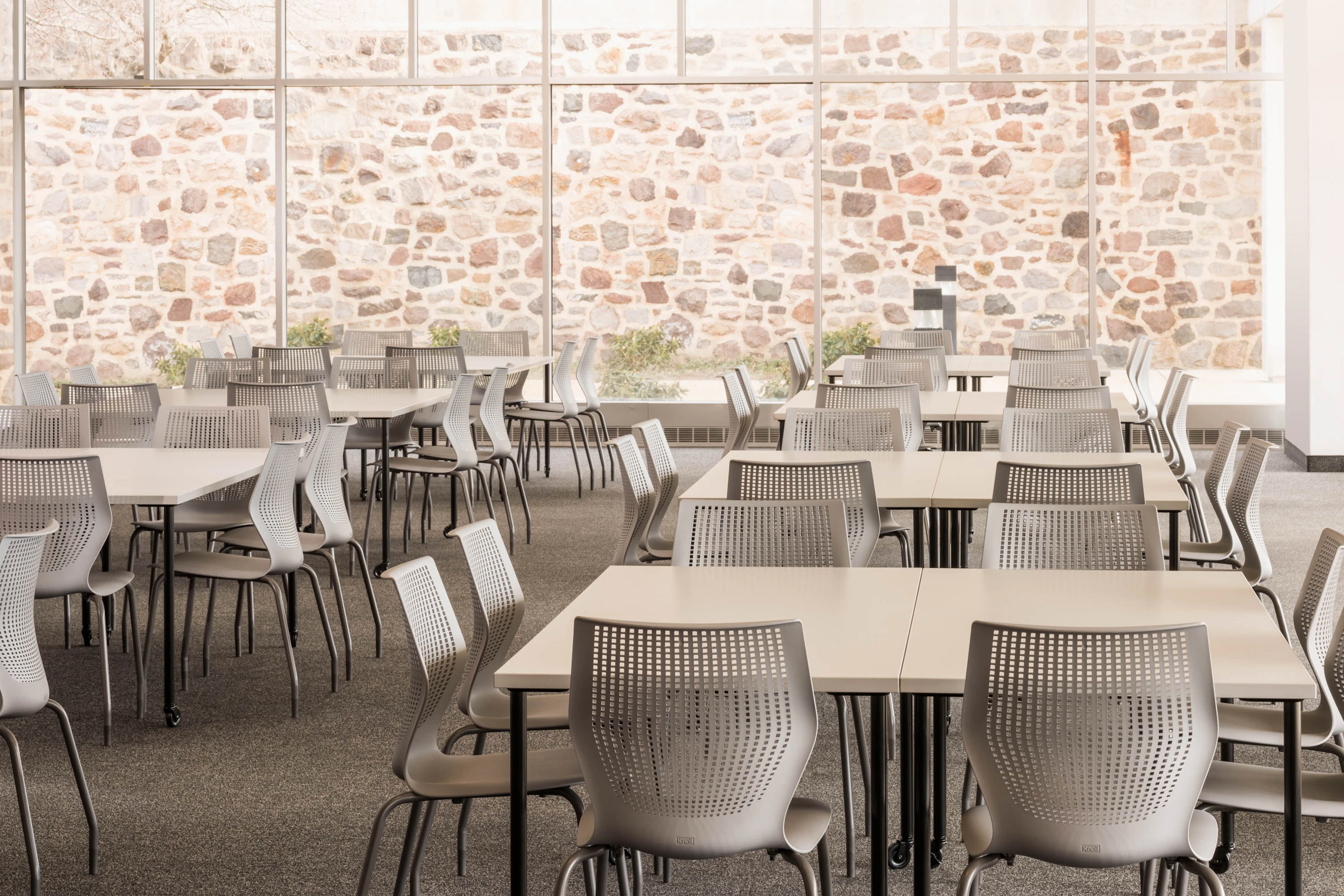 Knoll Antenna simple tables with black legs and MultiGeneration by Knoll chairs for a café
