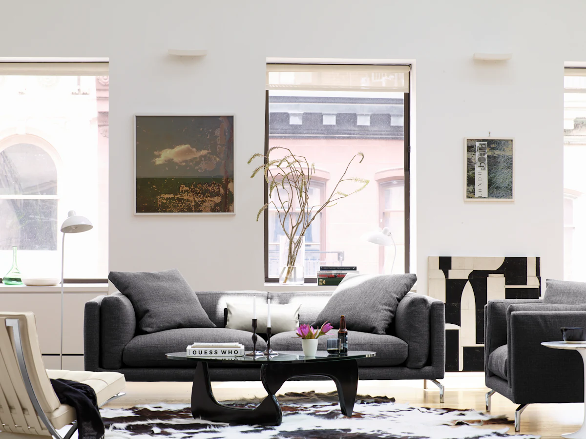Two gray sofas in a bright living room with a central black coffee table