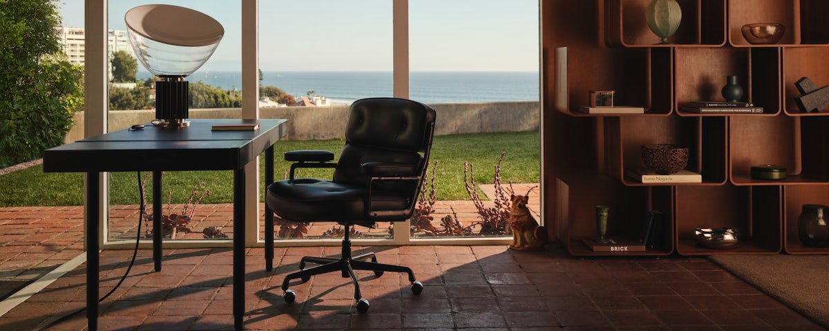 Taccia Table Lamp, Leathwrap Desk and Eames Executive Chair in a home office setting