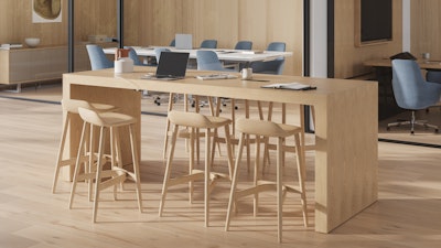 An environmental image of the JD Waterfall Table, by DatesWeiser, in an office kitchen setting. With Leeway Stools, Tuxedo Sofa and Bumper Lounge Chair reception area.