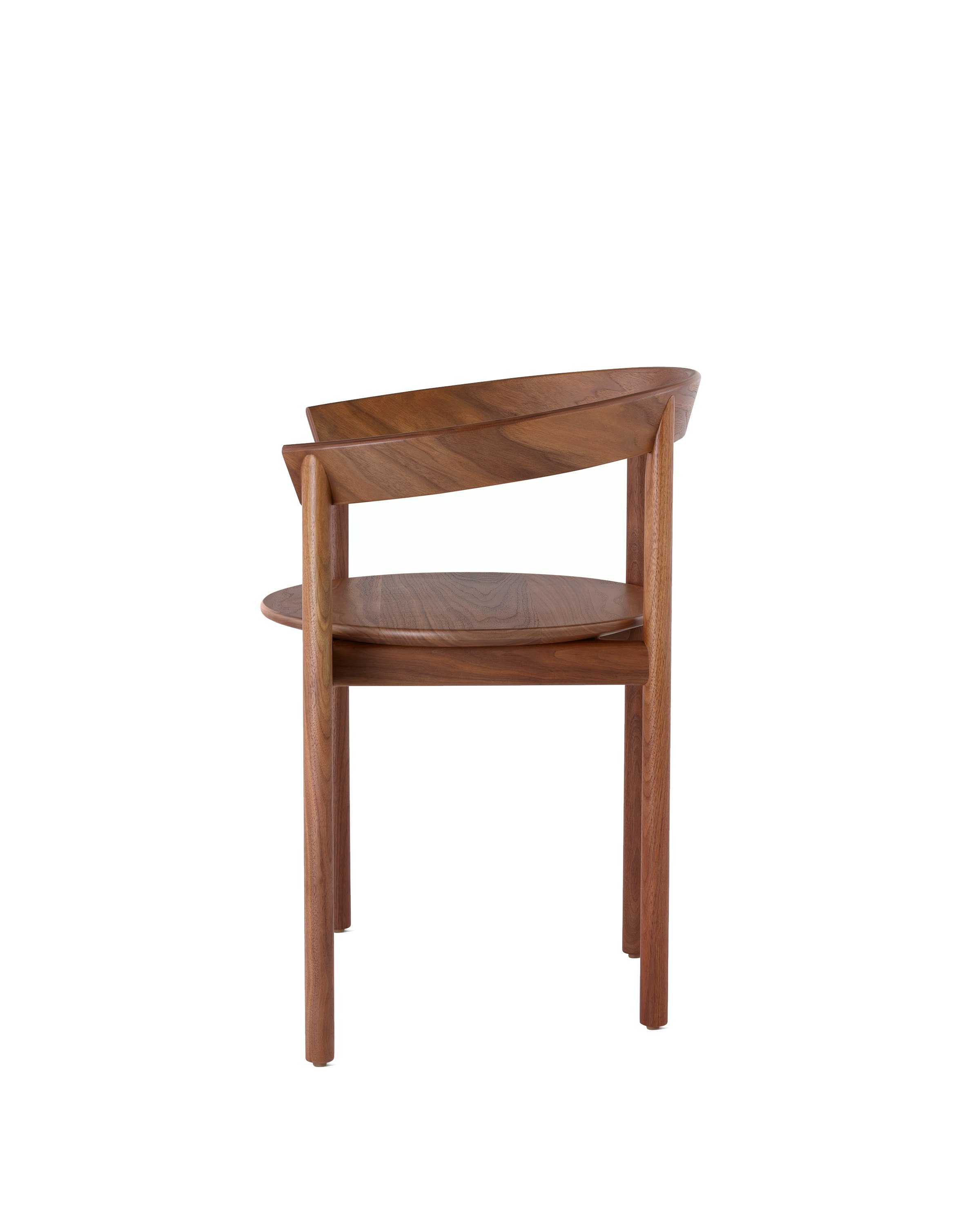 Profile view of a walnut Comma Chair with arms.