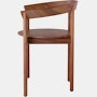 Profile view of a walnut Comma Chair with arms.