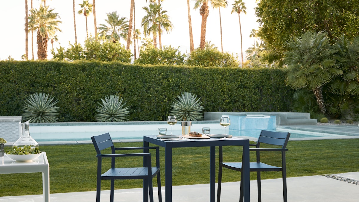 Eos Dining Chair and Table at a poolside setting