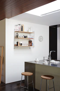 String Wall Shelving in Kitchen with two oak seat and chrome leg base Cornet Barstools.
