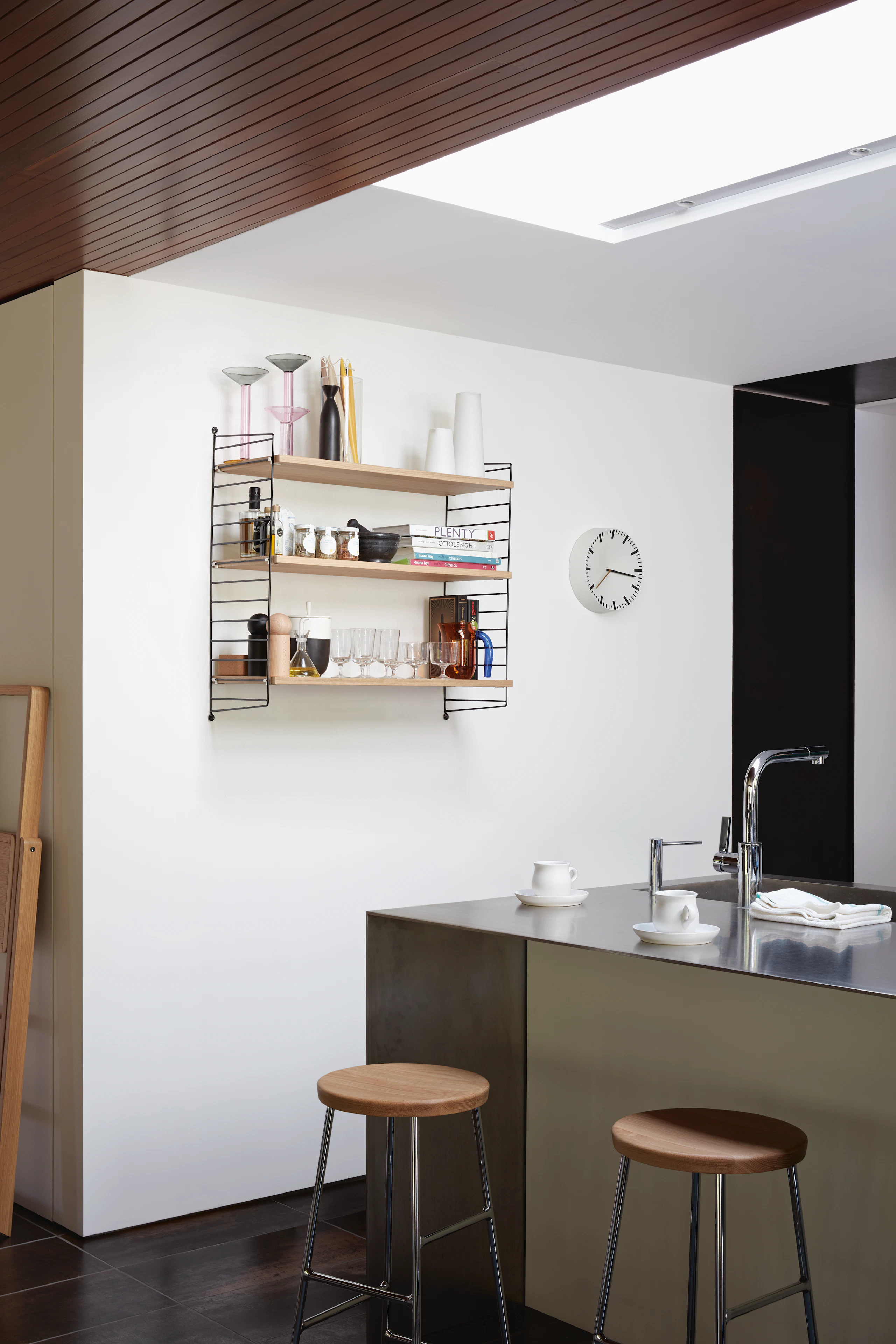 String Wall Shelving in Kitchen with two oak seat and chrome leg base Cornet Barstools.