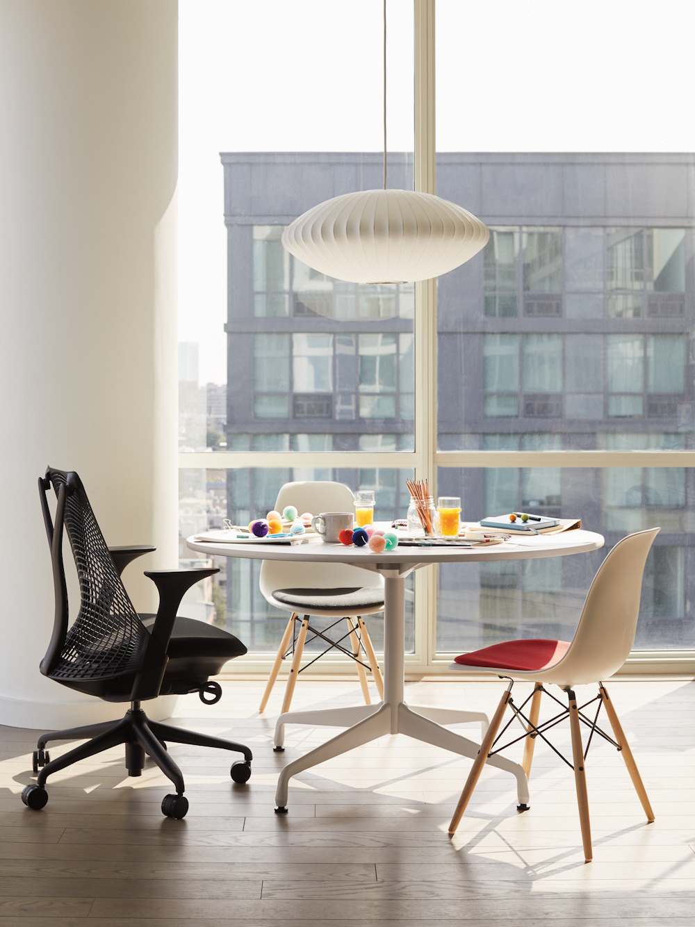 Eames Table with Round Top and Segmented Base with Sayl Chair and Eames Shell Side Chairs with Seatpad