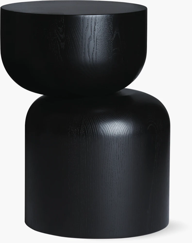 Close-up of a black wooden table leg with a rounded knob