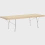 A Nelson Cane Bench with a walnut frame and metal legs, viewed at an angle.