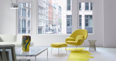 The Knoll showroom at 251 Park Avenue South in New York City featuring a marble coffee table, white sofa, and yellow Knoll Womb Chair and Ottoman