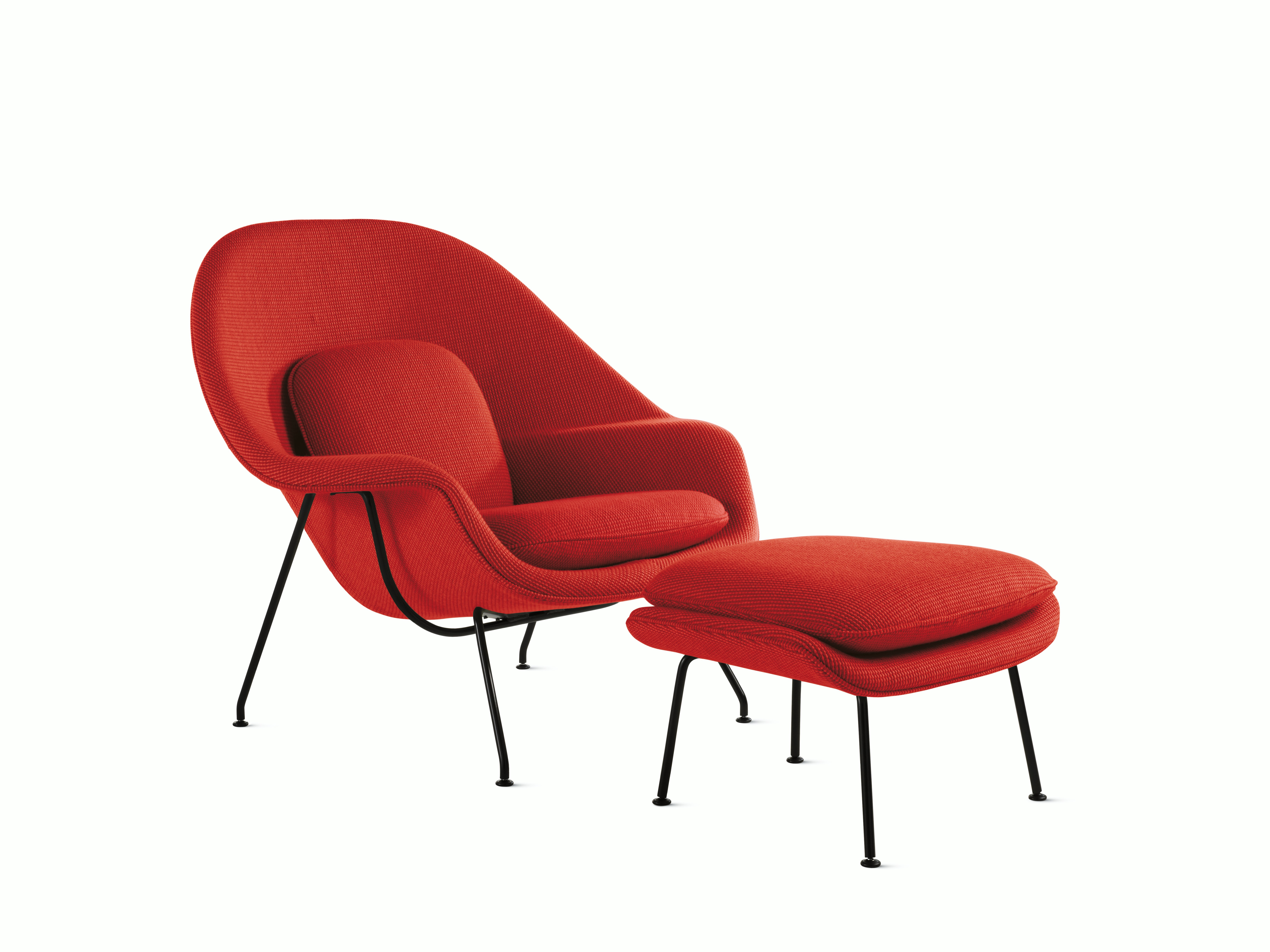 A fire red Womb Chair & Ottoman viewed from an angle.