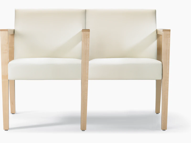 A front view of a Brava 863 two-seat multiple and tandem chair with intervening arms and legs upholstered in white textile with solid maple arms and legs.