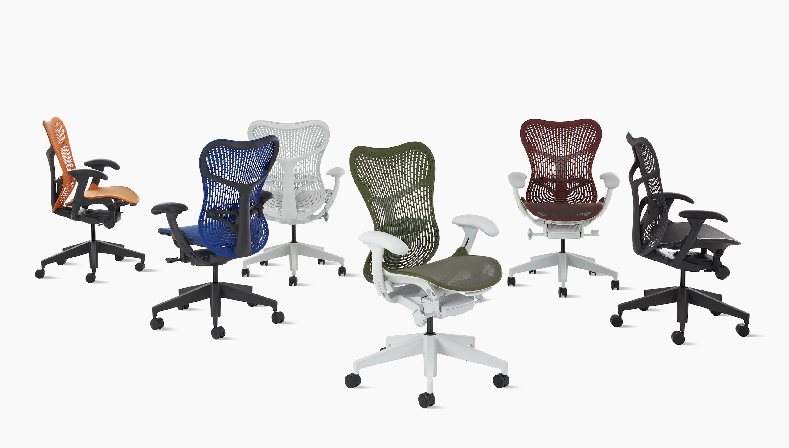 A group of six Mirra 2 chairs in a row in multiple colors with Triflex backs.