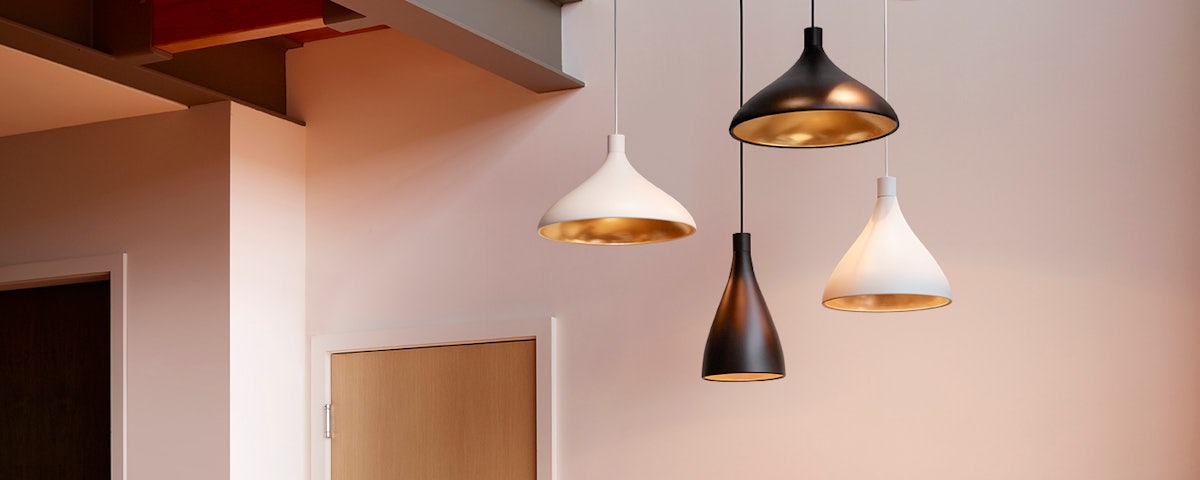 Black and white Swell Pendants hanging from ceiling