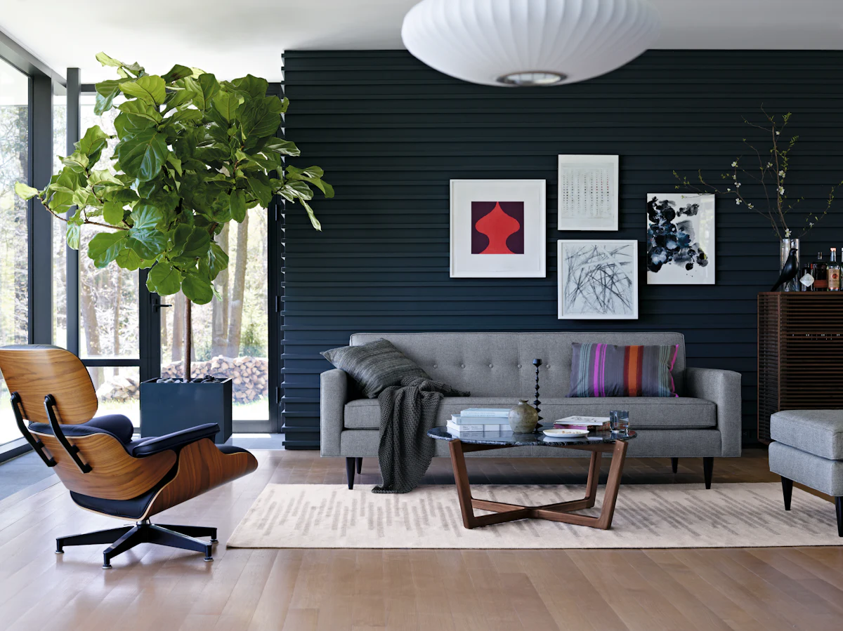 Living room with dark accent wall, gray sofa, wooden coffee table, and white rug.