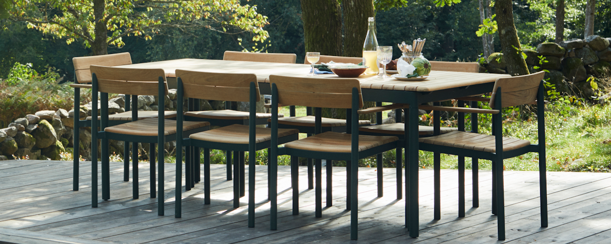 Pelagus Dining Table surrounded by Pelagus Dining Chairs in an outdoor patio setting