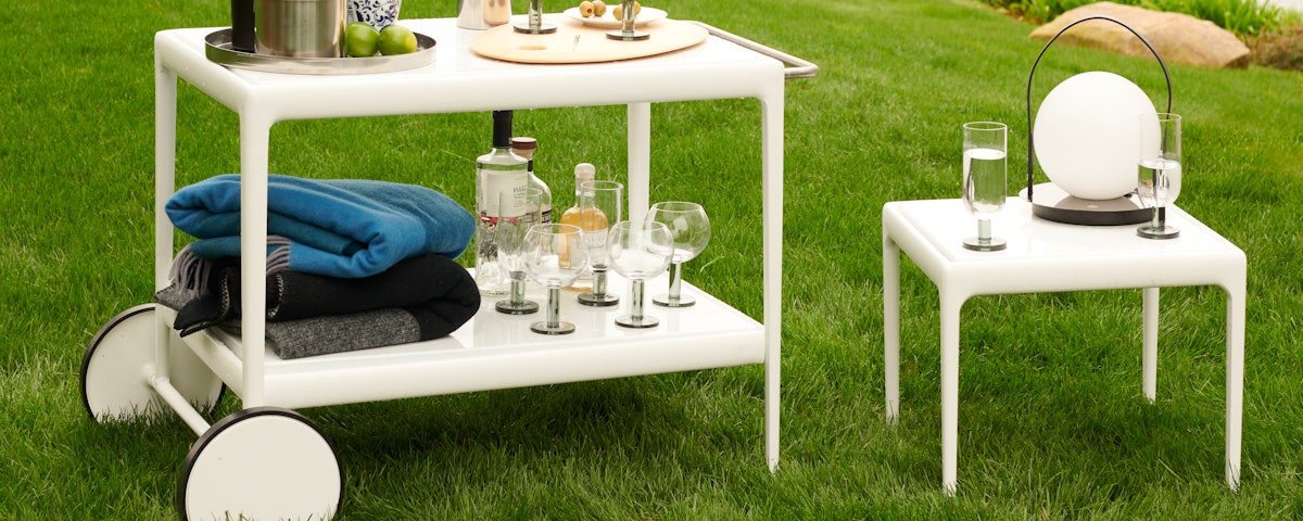 1966 Porcelain Serving Cart and 1966 Coffee/Side Table in an outdoor lawn setting