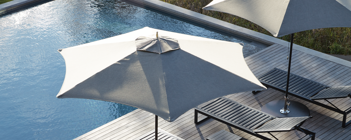 Tuuci Ocean Master Hexagon Umbrellas and EOS Chaise Lounge Chairs at a poolside setting
