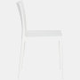A cream white Elementaire Side Chair viewed from the side.