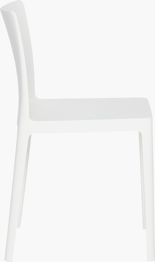 A cream white Elementaire Side Chair viewed from the side.