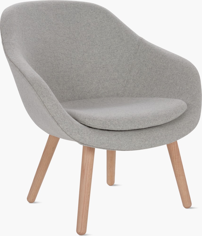 A light grey About a Lounge 82 Armchair with low back viewed from an angle