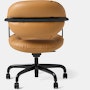Rear view of a Morrison Hannah chair with a black frame and base with fixed arms and light brown leather upholstery.