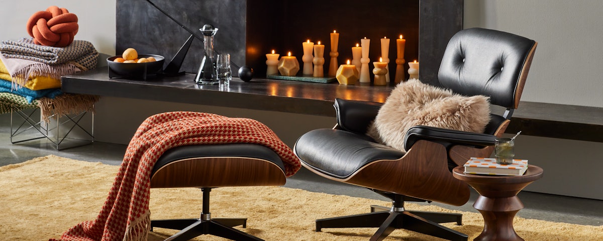Sheepskin Throw Pillow with Eames Lounge Chair and Ottoman on Ruti Moroccan Rug in home living room setting