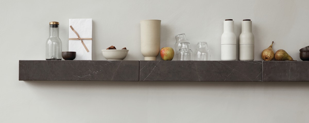 Plinth Shelf on wall holding kitchen accessories