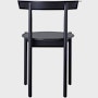 A black Comma Chair, viewed from the back.