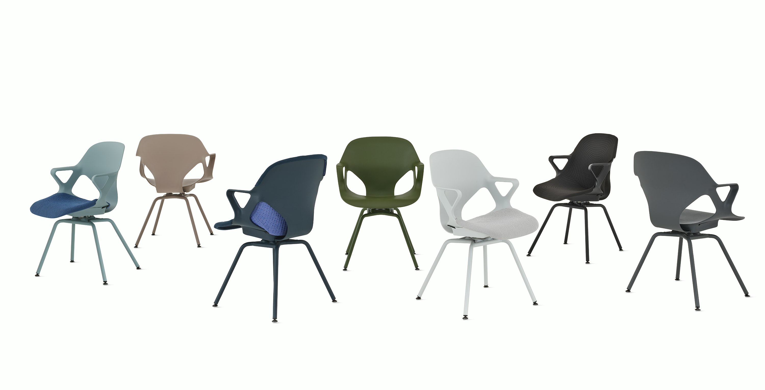 A group of seven Zeph side chairs with fixed arms in all available colors . Some chairs have knit seat pads and unibody's.