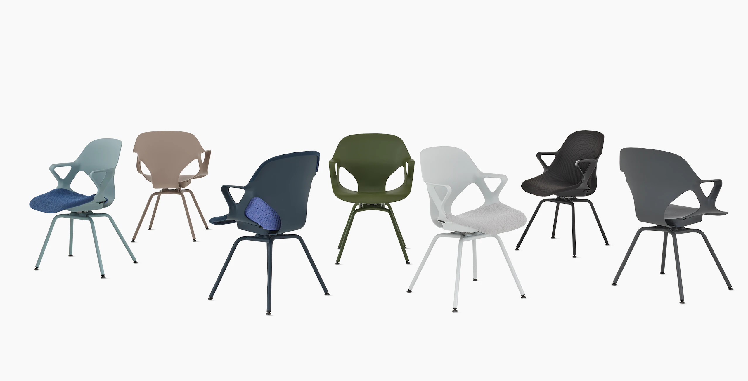 A group of seven Zeph side chairs with fixed arms in all available colors . Some chairs have knit seat pads and unibody's.