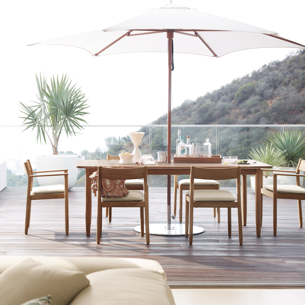 Tuuci Ocean Master Hexagon Umbrella and Terassi Dining Set in an outdoor patio setting
