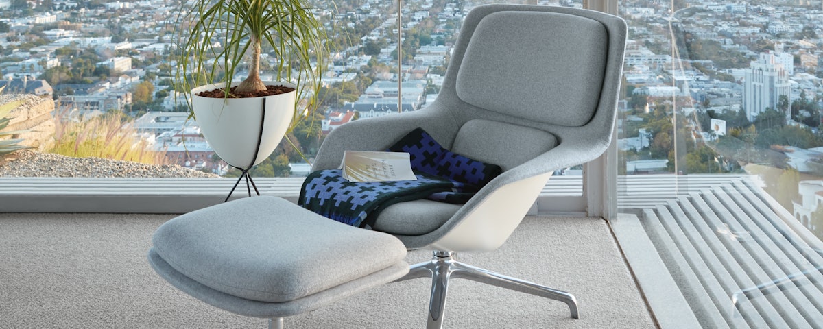 Striad Lounge Chair and Ottoman in a modern living room setting