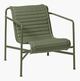 A three quarter view of a Palissade Lounge Chair Low Quilted Cushion in olive green. A three quarter view of a Palissade Lounge Chair Low Quilted Cushion in olive green.