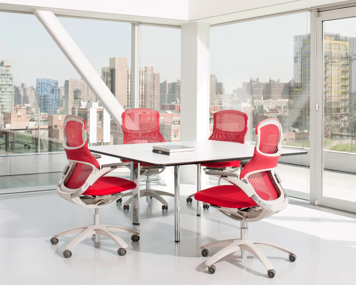 Close-up of a black ergonomic task chair with a mesh back and chrome base