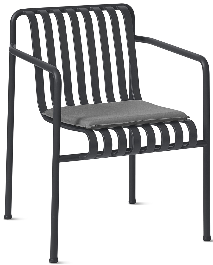A front angle view of the Palissade Dining Armchair with Seat Cushion in dark grey.