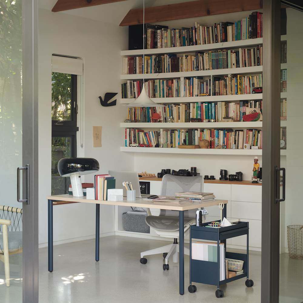 Light brown and blue OE1 Rectangular Table and blue OE1 Storage Trolley with a light grey low-back Cosm Chair in a home office setting.