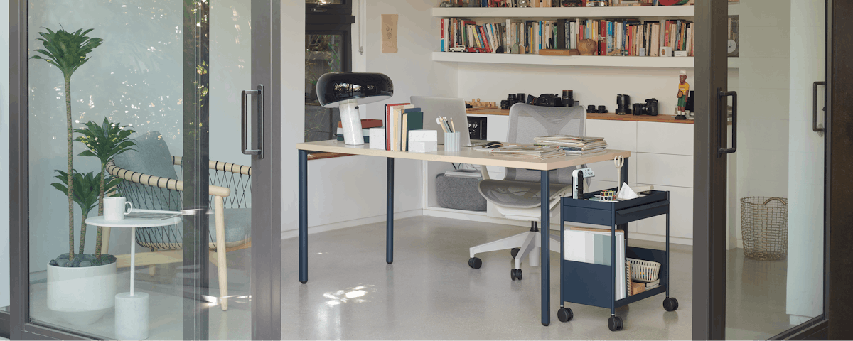 Light brown and blue OE1 Rectangular Table and blue OE1 Storage Trolley with a light grey low-back Cosm Chair in a home office setting