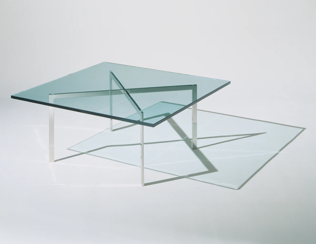 Set of modern leather and chrome chairs around a glass dining table