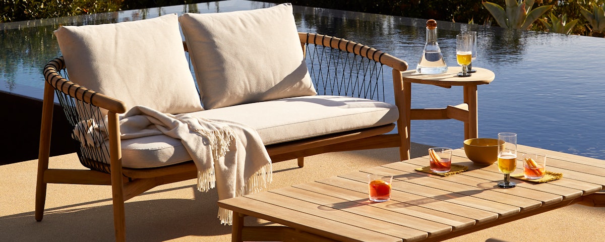 Crosshatch Outdoor Settee, Coffee Table and Side Table in an outdoor setting