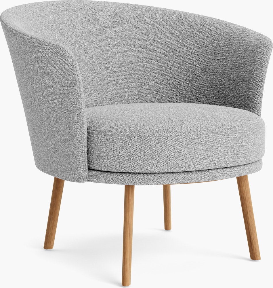 A front angle view of the Dorso Lounge Chair with grey seat and back, and oak legs.
