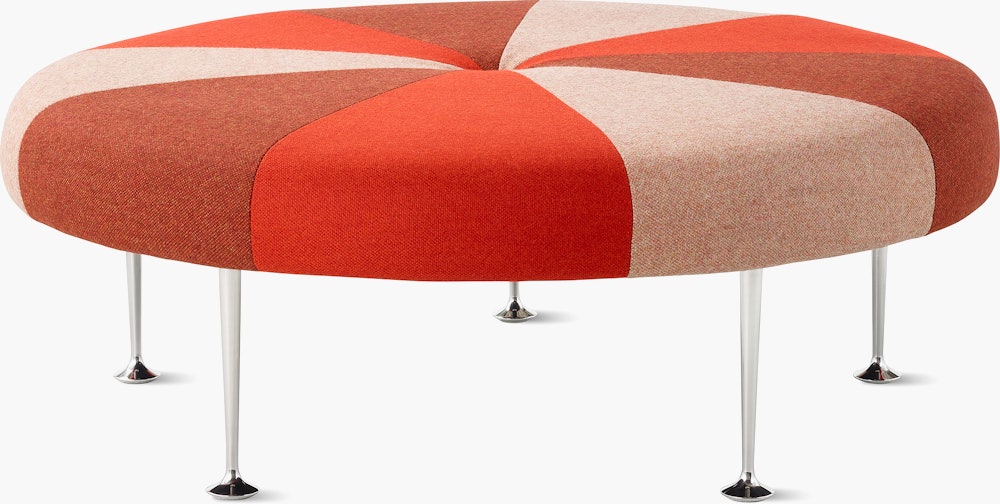 A Girard Color Wheel Ottoman upholstered in red fabrics, viewed from the side.