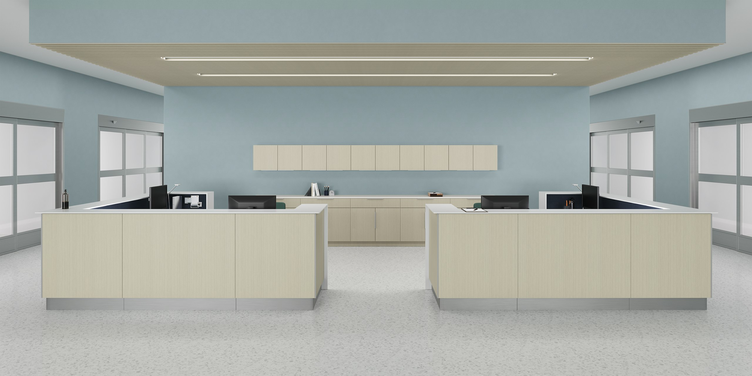 Prefab Commend Nurses Station for four with gray-beige patterned laminate fronts positioned within an inpatient clinic with Mora System...