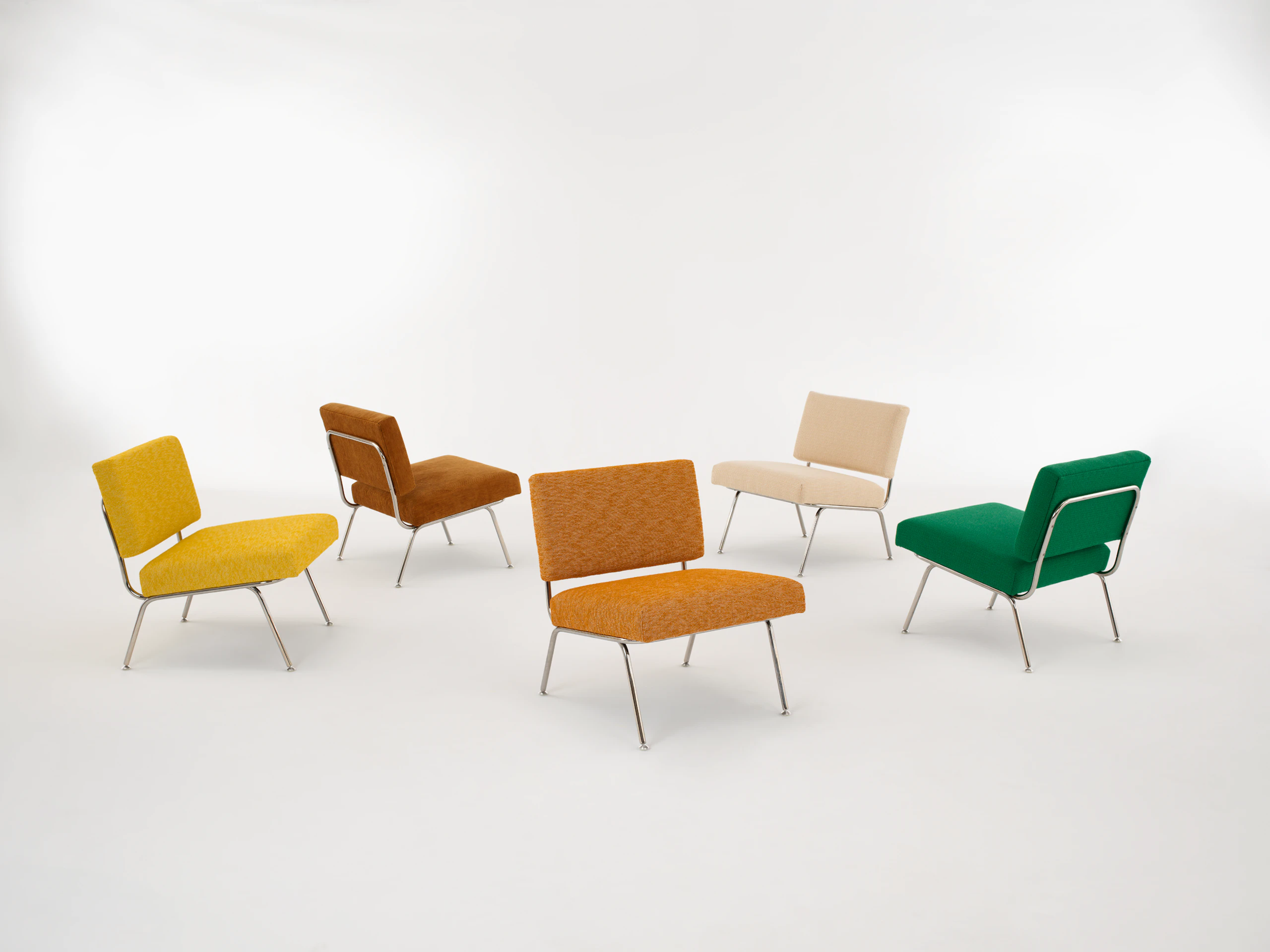 A collection of several Model 31 lounge chairs in different upholsteries.