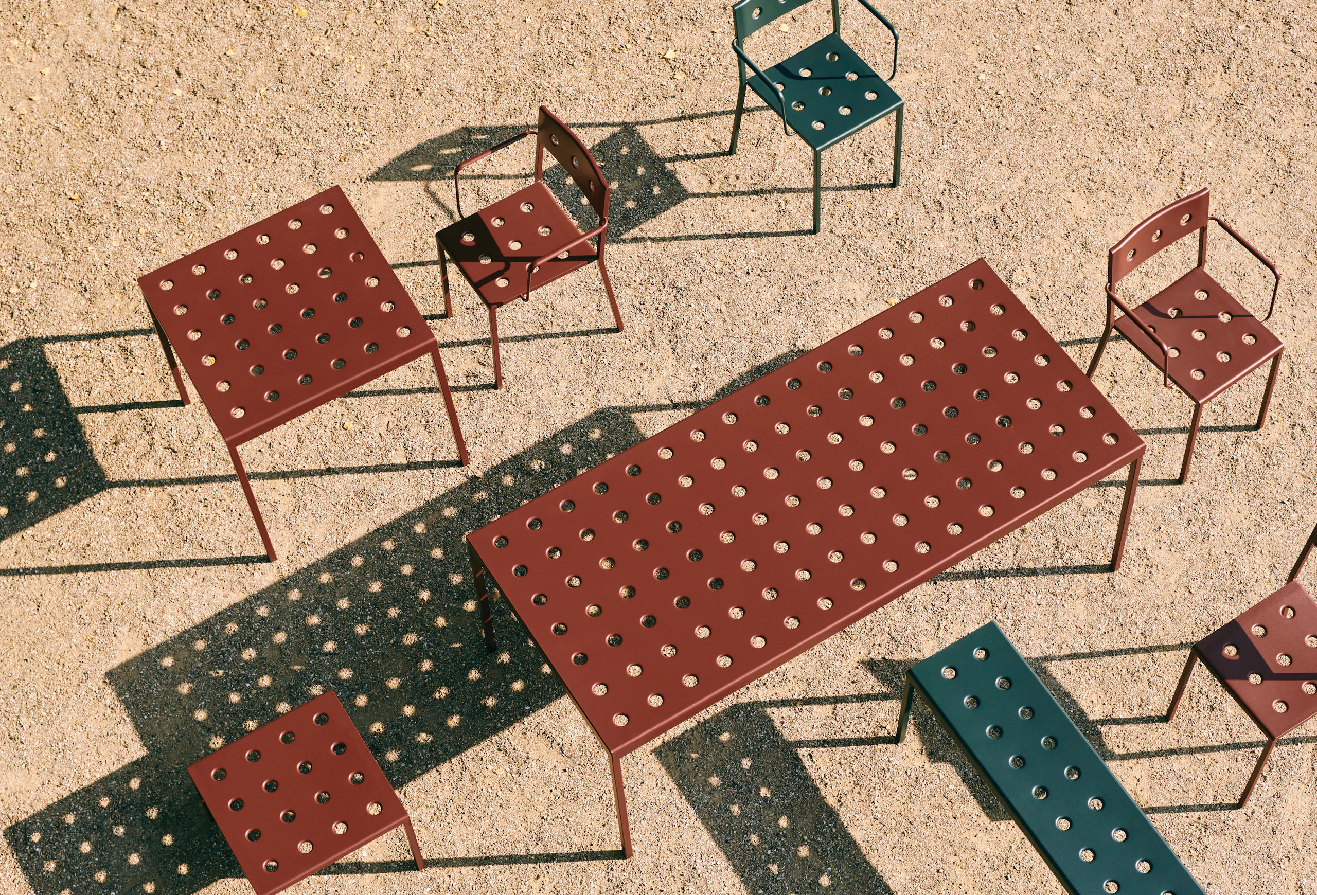 Red tables and chairs from Hay’s Balcony Collection of outdoor furniture.