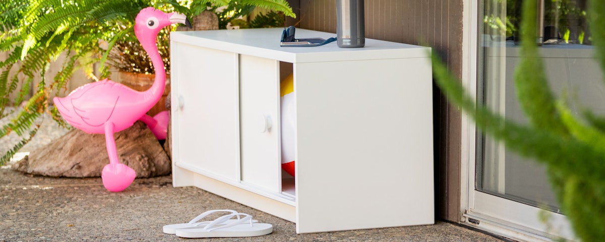 Slider Credenza holding pool float toys in an outdoor patio setting